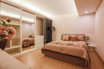 Cozy bedroom with modern furniture and built-in wardrobe