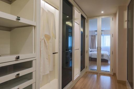 Modern bedroom with built-in wardrobe and glass door