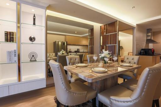 Elegant dining room with modern furniture and open concept kitchen