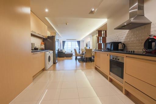 Modern kitchen with open floor plan extending to living and dining area