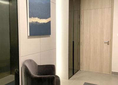 Modern entryway with artwork and comfortable chair