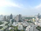 Panoramic cityscape view from a high-rise apartment balcony