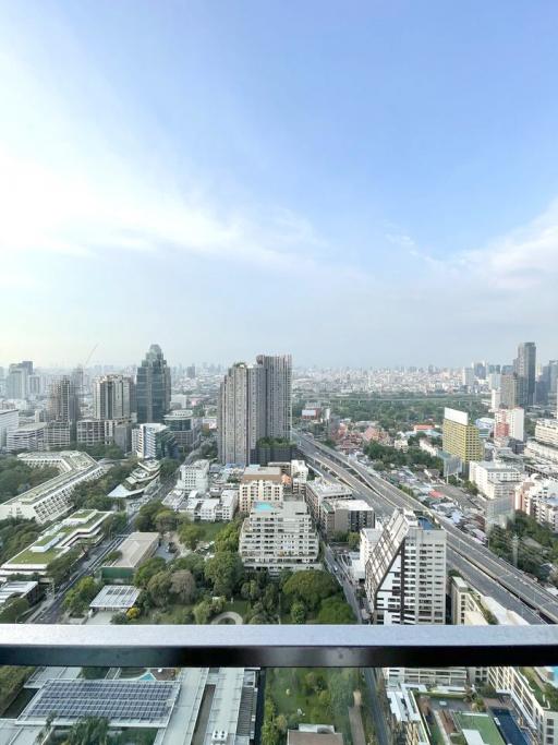 Panoramic cityscape view from a high-rise apartment balcony