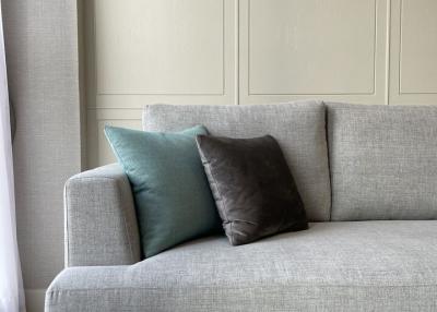 Elegant grey sofa with decorative cushions