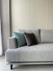 Elegant grey sofa with decorative cushions