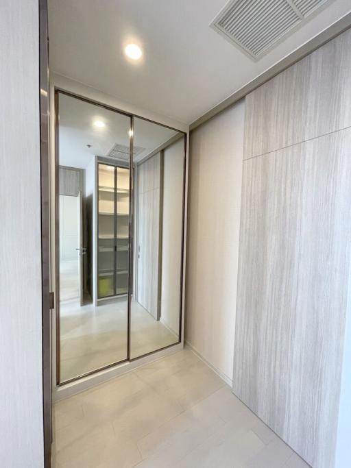 Modern corridor with tiled floor and sliding glass door