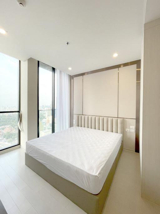 Spacious bedroom with large window and city view