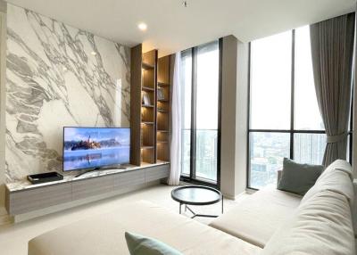 Modern living room with large windows and marble wall