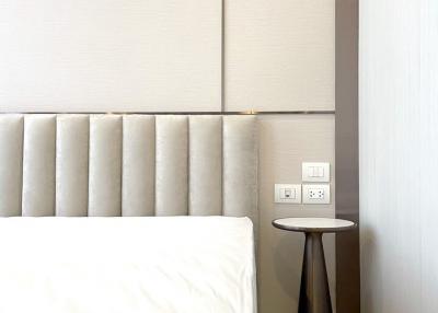 Cozy bedroom corner with elegant headboard and side table