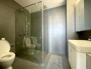 Modern bathroom with glass shower enclosure and wall-mounted toilet