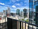 City view from balcony of high-rise apartment with clear sky