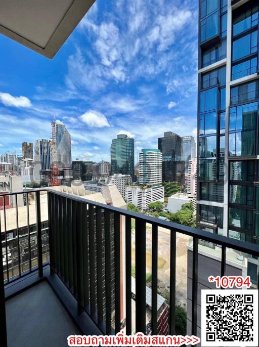 City view from balcony of high-rise apartment with clear sky