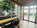 Elegant dining area with wooden flooring and large windows