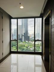 High-rise apartment interior with large window and city view