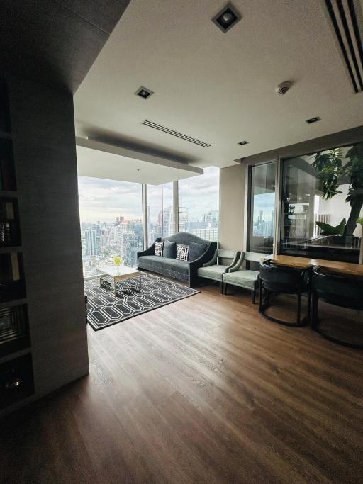 Spacious living room with large windows and city view