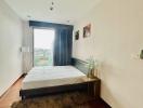 Cozy bedroom with wooden flooring and natural light