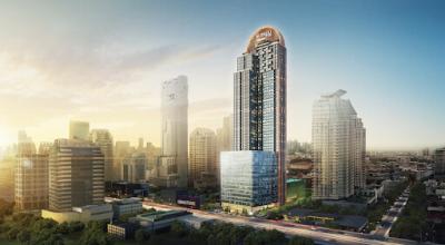 Modern high-rise residential building at twilight with cityscape background