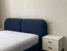 Modern Bedroom with Herringbone Pattern Wallpaper and Blue Bed