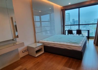 Modern bedroom with city view and ample lighting