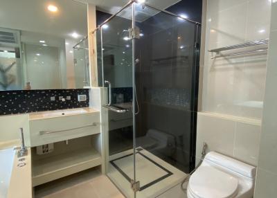 Modern bathroom with glass shower enclosure and white fixtures