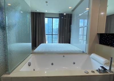 Spacious modern bathroom with jacuzzi and city view