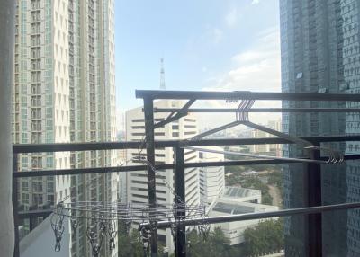 Modern high-rise building view from a balcony with metal railings