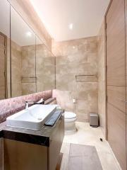 Modern bathroom with natural stone tiles and contemporary fixtures