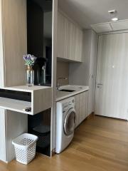 Compact modern kitchen with integrated appliances and wooden flooring