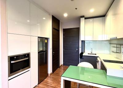 Modern kitchen with wooden flooring and built-in appliances