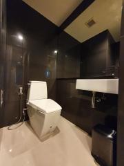 Modern bathroom interior with wall-mounted sink and toilet