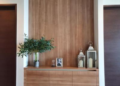 Elegant wooden feature wall with decorative items in a modern living space