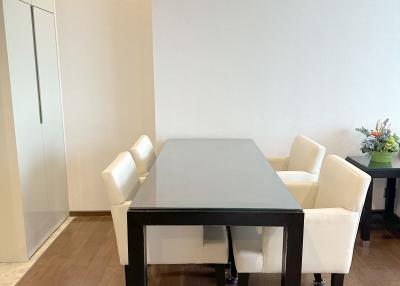 Modern dining area with wooden floor and natural light