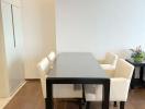 Modern dining area with wooden floor and natural light