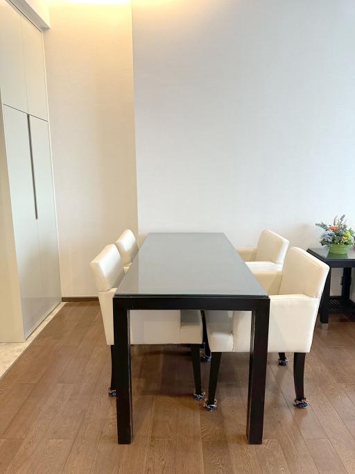 Modern dining area with wooden floor and natural light