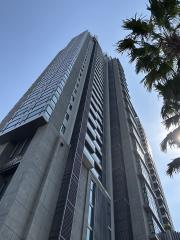 Modern high-rise residential building with a clear blue sky