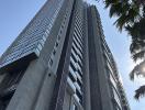 Modern high-rise residential building with a clear blue sky