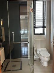 Modern bathroom interior with glass shower and window blinds