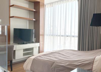 Modern bedroom with large windows and city view