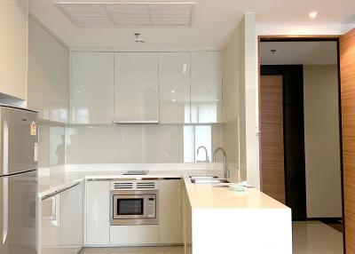 Modern kitchen with white cabinetry and stainless steel appliances