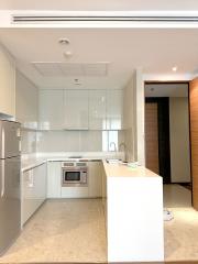 Modern kitchen with white cabinetry and stainless steel appliances