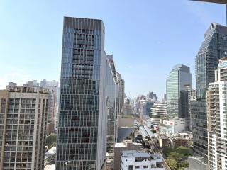 Panoramic cityscape view from a high-rise building balcony