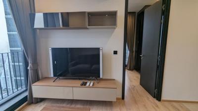 Modern living room with wide screen TV and balcony access