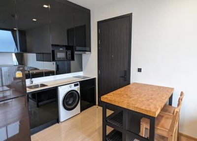 Modern kitchen with integrated appliances and wooden countertop