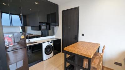 Modern kitchen with integrated appliances and wooden countertop