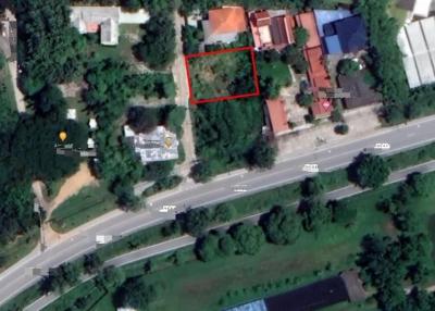 Aerial view of a property with a highlighted boundary adjacent to a road