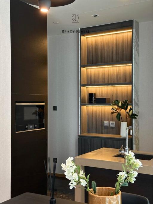 Modern and elegant interior space with illuminated shelving and decorative elements
