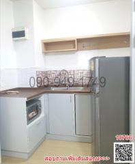 Modern compact kitchen with stainless steel refrigerator and built-in appliances
