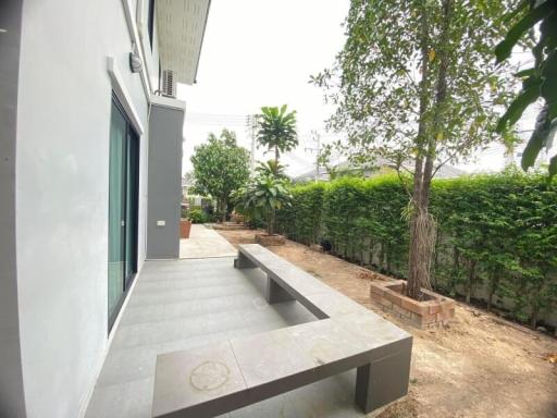 Spacious outdoor patio with seating and garden