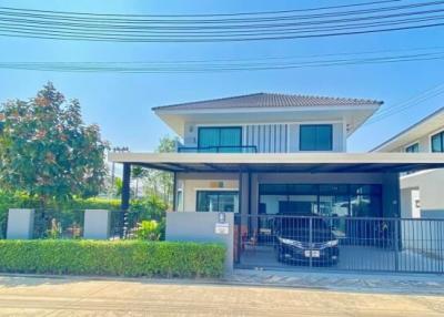 Modern two-storey residential home with a covered carport and gated entrance