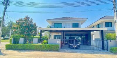 Modern two-storey residential home with a covered carport and gated entrance